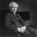 Black and White photo of Bela Bartok in his mid-forties sat in a chair
