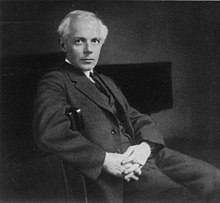 Black and White photo of Bela Bartok in his mid-forties sat in a chair