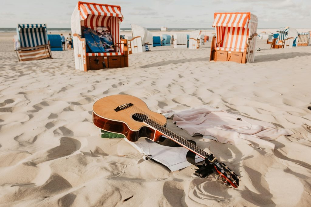 Heat survival tips with guitar on a hot beach